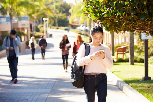 College students using their phones to purchase things
