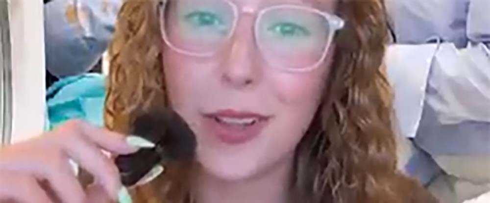 A woman speaking into a small mic, going over laundry tips