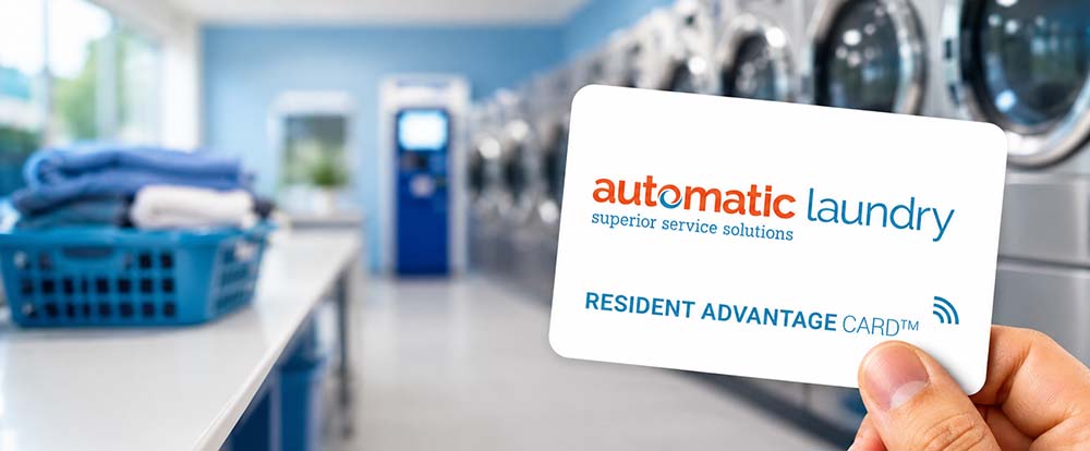 A hand holding Automatic Laundry's white laundry card in a laundry room