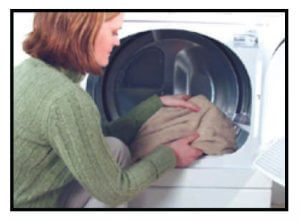 woman using a laundry machine